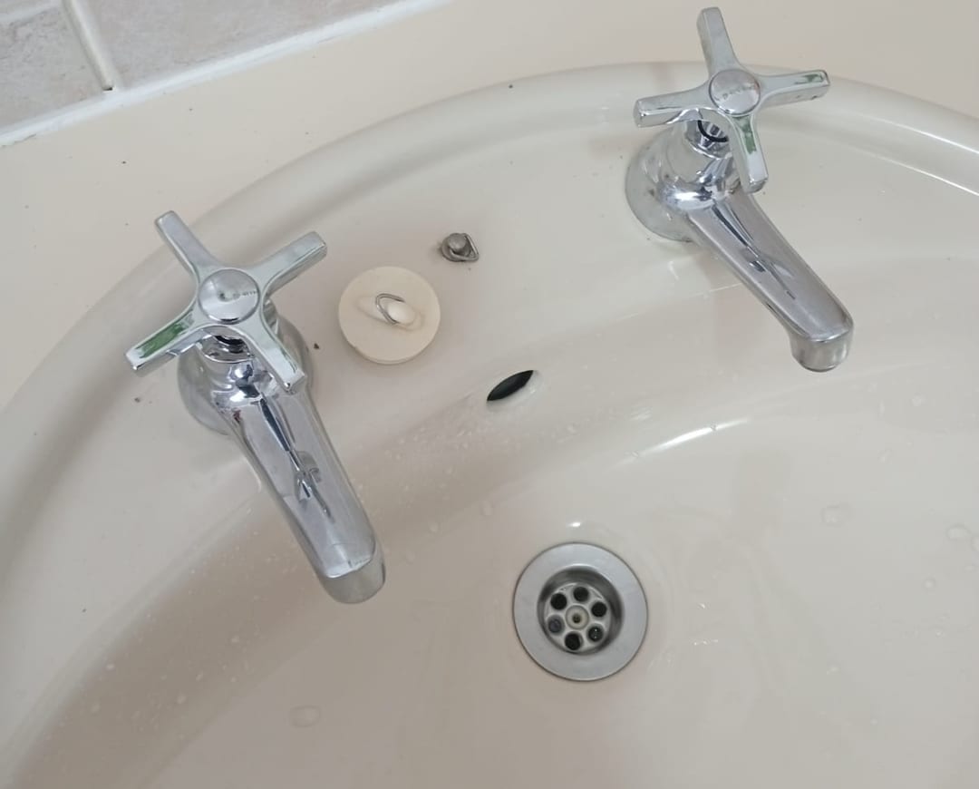 New chrome cross-handle pillar taps fitted to a bathroom basin