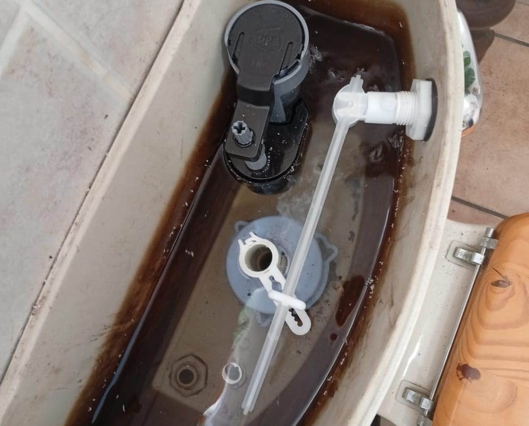 Inside a toilet cistern with a new inlet valve and flush mechanism fitted